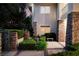Beautiful home facade with stone accents, manicured shrubs and a gated entrance at 605 Canyon Greens Dr, Las Vegas, NV 89144