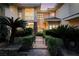 Elegant home exterior with a gated entrance, mature palm trees, and manicured landscaping at 605 Canyon Greens Dr, Las Vegas, NV 89144