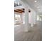 Bright hallway featuring hardwood floors, white columns, and ample natural light at 605 Canyon Greens Dr, Las Vegas, NV 89144