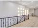 Bright hallway with decorative iron railing and multiple windows allowing natural light at 605 Canyon Greens Dr, Las Vegas, NV 89144