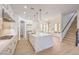 Open kitchen with a large island, stainless appliances, ample cabinet space, and a view of the staircase at 605 Canyon Greens Dr, Las Vegas, NV 89144