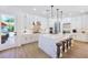 Modern kitchen with white cabinets, marble countertops, and stainless steel appliances at 605 Canyon Greens Dr, Las Vegas, NV 89144