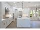 Modern kitchen with white cabinets, a large marble island, and stainless steel appliances at 605 Canyon Greens Dr, Las Vegas, NV 89144