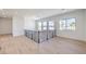 Bright upstairs landing area with wood floors, decorative wrought iron railing, and large windows at 605 Canyon Greens Dr, Las Vegas, NV 89144