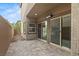 Covered back patio with brick pavers and sliding glass doors at 9143 Irish Elk Ave, Las Vegas, NV 89149