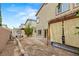 Expansive backyard featuring a covered patio with curtains, stone pavers, and a cozy seating area, great for outdoor living at 9143 Irish Elk Ave, Las Vegas, NV 89149