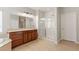 Bathroom featuring a vanity with a large mirror, a glass-enclosed shower, and tile flooring at 9143 Irish Elk Ave, Las Vegas, NV 89149