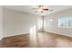 Bright bedroom with plank flooring, a ceiling fan, and dual windows offering plenty of light at 9143 Irish Elk Ave, Las Vegas, NV 89149