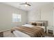 Neutral bedroom featuring a queen bed with a tan comforter, side tables, and carpeted floors at 9143 Irish Elk Ave, Las Vegas, NV 89149