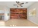 Spacious bedroom with a wood accent wall and neutral flooring and a ceiling fan at 9143 Irish Elk Ave, Las Vegas, NV 89149