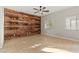 Bright bedroom featuring a unique wood accent wall and tile flooring, plus lots of natural light at 9143 Irish Elk Ave, Las Vegas, NV 89149