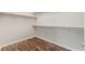 A closet with wood laminate flooring and built-in shelves at 9143 Irish Elk Ave, Las Vegas, NV 89149