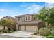 Attractive two-story home with stone accents, a tiled roof, and well-maintained landscaping enhancing its curb appeal at 9143 Irish Elk Ave, Las Vegas, NV 89149