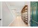 Bright foyer with tile flooring, showcasing the staircase and open entryway, storage shelves, with an inviting view at 9143 Irish Elk Ave, Las Vegas, NV 89149
