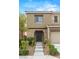 A close-up of the home's front entrance with stone accents and manicured landscaping leading to the front door at 9143 Irish Elk Ave, Las Vegas, NV 89149