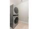 Compact laundry room featuring a stacked washer and dryer unit, maximizing space at 9143 Irish Elk Ave, Las Vegas, NV 89149