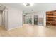 Expansive living room with tile flooring, featuring sliding doors to the outdoor patio and rustic wood accent wall at 9143 Irish Elk Ave, Las Vegas, NV 89149