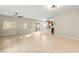 Spacious living room with tile flooring and sliding doors to the backyard, adjacent to the kitchen at 9143 Irish Elk Ave, Las Vegas, NV 89149