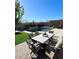 Inviting backyard with pool, patio furniture, and lush landscaping at 12113 Rojo Roma Ave, Las Vegas, NV 89138