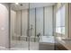 Large bathroom with a walk-in shower and soaking tub; contemporary design at 12113 Rojo Roma Ave, Las Vegas, NV 89138