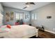 Bedroom with a queen-size bed, desk, and striped wall at 12113 Rojo Roma Ave, Las Vegas, NV 89138