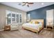 Spacious primary bedroom with a large bed, comfortable seating, and plenty of natural light at 12113 Rojo Roma Ave, Las Vegas, NV 89138