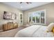 Bright bedroom with a king-size bed, large TV, and access to a private patio at 12113 Rojo Roma Ave, Las Vegas, NV 89138