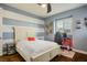 Bedroom with a queen-size bed, desk, and striped wall at 12113 Rojo Roma Ave, Las Vegas, NV 89138