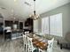Bright dining room with farmhouse table and white plantation shutters at 12113 Rojo Roma Ave, Las Vegas, NV 89138