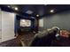 Home theater with comfortable seating and large screen TV at 12113 Rojo Roma Ave, Las Vegas, NV 89138