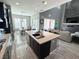 Island kitchen with stainless steel appliances and views into living and dining areas at 12113 Rojo Roma Ave, Las Vegas, NV 89138