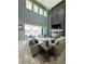 Bright living room with a fireplace, large windows, and access to patio at 12113 Rojo Roma Ave, Las Vegas, NV 89138