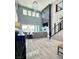 Two-story living room featuring a fireplace, chandelier, and patio access at 12113 Rojo Roma Ave, Las Vegas, NV 89138