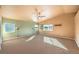Large bedroom with carpet, ceiling fan, and multiple windows at 315 Foster Springs Rd, Las Vegas, NV 89148
