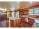 Open kitchen with island, wood cabinets, and stainless steel appliances at 315 Foster Springs Rd, Las Vegas, NV 89148
