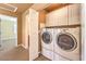 Convenient laundry room with washer, dryer, and cabinets at 315 Foster Springs Rd, Las Vegas, NV 89148