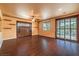 Living room with hardwood floors, built-in shelving, and access to patio at 315 Foster Springs Rd, Las Vegas, NV 89148