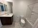 Clean bathroom with a vanity, a toilet, and a shower-tub combination with white tile surround at 3245 Montage Dr, Henderson, NV 89044