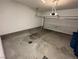Open garage space with a concrete floor and a partially open garage door at 3245 Montage Dr, Henderson, NV 89044