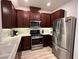 Modern kitchen features stainless steel appliances, granite countertops, and dark wood cabinets at 3245 Montage Dr, Henderson, NV 89044
