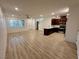 Open concept living space featuring wood floors, modern ceiling fan, stainless appliances, and recessed lighting at 3245 Montage Dr, Henderson, NV 89044