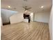 Open-concept living space features hardwood floors, a modern ceiling fan, and staircase access at 3245 Montage Dr, Henderson, NV 89044