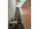 Carpeted staircase with white banister and motorized chair lift at 3245 Montage Dr, Henderson, NV 89044