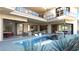 Luxury backyard with a modern pool, fire pit, and multiple seating areas under a covered patio with an adjacent wine room at 4 Olympia Summit Dr, Las Vegas, NV 89141