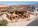 Exterior view of a new two-story home under construction, showcasing the framing, roof tile, and the surrounding landscape at 4 Olympia Summit Dr, Las Vegas, NV 89141