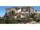 View of the side and rear of a two-story home with desert landscaping at 4 Olympia Summit Dr, Las Vegas, NV 89141