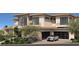 Contemporary two-story home with a two-car garage and desert landscaping at 4 Olympia Summit Dr, Las Vegas, NV 89141