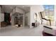 Contemporary foyer featuring a floating staircase, bar area, wine storage, and modern decor with natural light at 4 Olympia Summit Dr, Las Vegas, NV 89141