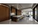 Open-concept kitchen with a large island, bar seating, modern appliances, and a seamless flow to the living area and exterior views at 4 Olympia Summit Dr, Las Vegas, NV 89141