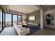 Bright living room with modern furnishings, large windows, and a spiral staircase at 4 Olympia Summit Dr, Las Vegas, NV 89141